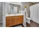 Well-maintained bathroom with oak vanity, framed mirror, and a walk-in closet, offering both style and functionality at 2289 Salem Park Dr, Indianapolis, IN 46239