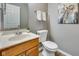 Cozy half bathroom featuring neutral walls, a decorative mirror, and a modern sink and toilet at 2289 Salem Park Dr, Indianapolis, IN 46239