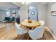 Open-concept dining area with table for four, bright light, and access to the living room at 2289 Salem Park Dr, Indianapolis, IN 46239