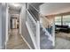 Hallway with staircase, view into the living room and kitchen with stainless steel appliances at 2289 Salem Park Dr, Indianapolis, IN 46239
