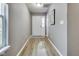 Bright entryway features durable wood-look flooring, neutral paint, and a welcoming front door with sidelight at 2289 Salem Park Dr, Indianapolis, IN 46239
