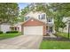 Charming two-story home with a brick accent and a two-car garage, nestled among mature trees at 2289 Salem Park Dr, Indianapolis, IN 46239