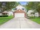 Inviting two-story home boasts a two-car garage, tidy lawn, and mature trees surrounding the property at 2289 Salem Park Dr, Indianapolis, IN 46239