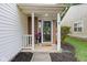 Cozy front porch with brick columns, decorative wreath on door, and a friendly 'hello' doormat at 2289 Salem Park Dr, Indianapolis, IN 46239