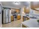 Well-lit kitchen with stainless steel appliances, wooden cabinetry, and ample countertop space at 2289 Salem Park Dr, Indianapolis, IN 46239