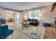 Spacious living room with fireplace, modern furniture, an area rug, and open layout to dining area at 2289 Salem Park Dr, Indianapolis, IN 46239