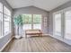Bright sunroom featuring large windows, a bench, and a tree, ideal for relaxation and natural light at 2289 Salem Park Dr, Indianapolis, IN 46239