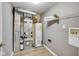 Utility room with water heater, furnace, and shelving, providing functional space for home maintenance and storage at 2289 Salem Park Dr, Indianapolis, IN 46239