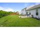 Spacious backyard with patio, a wooden fence, and well-maintained lawn, ideal for outdoor enjoyment at 2421 Creek Bank Dr, Columbus, IN 47201