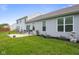 Backyard with patio, lawn, and landscaped area featuring flowering shrubs and stone decoration at 2421 Creek Bank Dr, Columbus, IN 47201