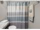 Bathroom with a white and blue striped shower curtain and towel rack with a plush towel at 2421 Creek Bank Dr, Columbus, IN 47201