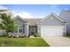 Charming single-story home featuring stone accents, gray siding, and a well-manicured front yard at 2421 Creek Bank Dr, Columbus, IN 47201