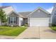 Charming single-story home featuring stone accents, gray siding, and a well-manicured front yard at 2421 Creek Bank Dr, Columbus, IN 47201