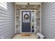 Close-up of the front door, showcasing the decorative wreath and stone surround at 2421 Creek Bank Dr, Columbus, IN 47201