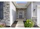 Inviting front entrance with a decorative wreath, stone accents, and a cozy bench at 2421 Creek Bank Dr, Columbus, IN 47201