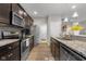 Modern kitchen featuring dark cabinets, granite countertops, and stainless steel appliances at 2421 Creek Bank Dr, Columbus, IN 47201
