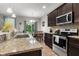 Charming kitchen features granite countertops and a dining area with sliding glass doors at 2421 Creek Bank Dr, Columbus, IN 47201