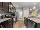 A well-designed kitchen features dark wood cabinets, stainless steel appliances, and modern finishes at 2421 Creek Bank Dr, Columbus, IN 47201