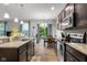 Well-lit kitchen showcases granite countertops, stainless appliances, and a view to the backyard at 2421 Creek Bank Dr, Columbus, IN 47201