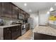 Spacious kitchen featuring dark wood cabinets, stainless steel appliances, and modern finishes at 2421 Creek Bank Dr, Columbus, IN 47201