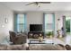 Relaxing living room with a ceiling fan, large windows and a glass coffee table at 2421 Creek Bank Dr, Columbus, IN 47201