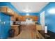Bright blue kitchen with oak cabinets, a black gas stove, and eat in dinette at 2610 Caroline Ave, Indianapolis, IN 46218