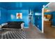 Bright blue living room leading into the kitchen with minimalist decor and carpet floors at 2610 Caroline Ave, Indianapolis, IN 46218