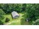 Aerial view of a property with a large garage, storage shed, and a vast, grassy yard surrounded by trees at 290 S Buffalo Hill Rd, Martinsville, IN 46151
