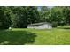 Backyard of a single-story home with a lush lawn and mature trees providing privacy and shade at 290 S Buffalo Hill Rd, Martinsville, IN 46151