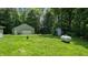 Spacious backyard with a detached garage, storage shed, and a propane tank, providing ample outdoor space at 290 S Buffalo Hill Rd, Martinsville, IN 46151