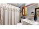 Compact bathroom with a shower/tub combination, decorative curtain, and a vanity with a sink at 290 S Buffalo Hill Rd, Martinsville, IN 46151