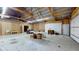 Spacious garage with high ceilings, exposed wood beams, and a large garage door at 290 S Buffalo Hill Rd, Martinsville, IN 46151