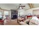 Cozy living room featuring a stone fireplace, plush furniture, and a ceiling fan at 290 S Buffalo Hill Rd, Martinsville, IN 46151
