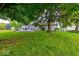 Spacious backyard features a lush green lawn, patio, and mature trees at 3025 Sable Ridge Ln, Greenwood, IN 46142