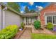 Inviting front porch adorned with potted plants, seating, and landscaped bushes, leading to the front door at 3025 Sable Ridge Ln, Greenwood, IN 46142