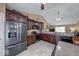 Modern kitchen boasts stainless steel appliances, dark cabinets, and a mosaic backsplash at 3025 Sable Ridge Ln, Greenwood, IN 46142