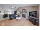 Open-concept living room with wood-look flooring, vaulted ceiling, fireplace, and view to the dining area at 3025 Sable Ridge Ln, Greenwood, IN 46142