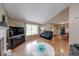 Open-concept living room with wood-look flooring, vaulted ceiling, fireplace, and a large window at 3025 Sable Ridge Ln, Greenwood, IN 46142