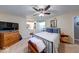 Comfortable primary bedroom includes a ceiling fan, carpet, and an ensuite bathroom at 3025 Sable Ridge Ln, Greenwood, IN 46142