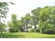 Expansive backyard with lush green lawn and mature trees creating a serene outdoor space at 3115 E 400 S, Anderson, IN 46017