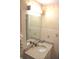 Bathroom with a granite countertop vanity, framed mirror, and floral accent decor at 3115 E 400 S, Anderson, IN 46017