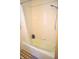 Clean bathroom featuring a bathtub-shower combo with neutral-colored tile at 3115 E 400 S, Anderson, IN 46017