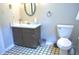 Well-maintained bathroom with dark wood vanity and patterned floor at 3115 E 400 S, Anderson, IN 46017