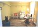 Sunlit bedroom with hardwood flooring, multiple chair styles, and overhead lighting at 3115 E 400 S, Anderson, IN 46017