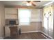 Spare bedroom features built-in shelving, a desk, a ceiling fan and hard wood flooring at 3115 E 400 S, Anderson, IN 46017