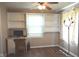 Spare bedroom features built-in shelving, a desk, a ceiling fan and hard wood flooring at 3115 E 400 S, Anderson, IN 46017