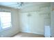 Bright bedroom featuring neutral paint colors, a ceiling fan, window, and wooden shelving at 3115 E 400 S, Anderson, IN 46017