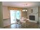 Cozy dining area with fireplace and sliding door to outdoor patio at 3115 E 400 S, Anderson, IN 46017