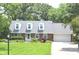 Charming brick home with dormer windows, lush lawn, and mature trees at 3115 E 400 S, Anderson, IN 46017