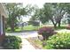 Well-maintained front yard showcasing a covered carport, lush greenery, and inviting curb appeal at 3115 E 400 S, Anderson, IN 46017